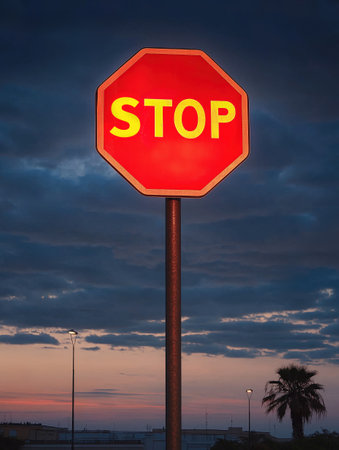 Stop sign at sunset with dramatic sky. Generative AIの素材