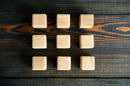 Blank wooden cubes over dark background. three-by-three grid. Flat layの写真素材