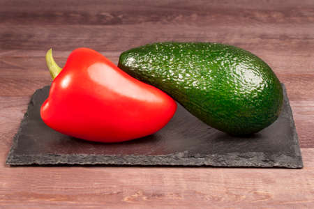 Red pepper and avocado on a stone tray