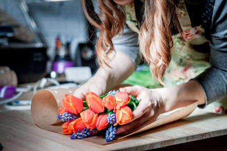 The florist assemble a bouquetの写真素材