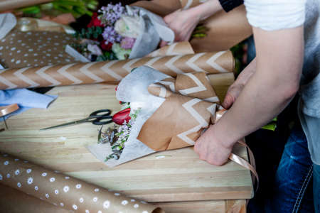 The florist assemble a bouquetの写真素材