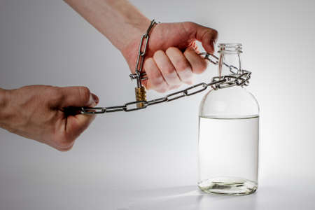 bottle with alcohol and chainの写真素材