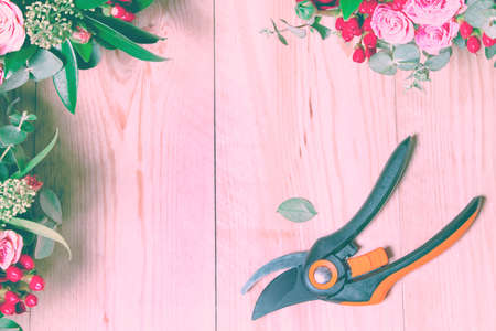 wooden background with flowers and secateursの写真素材