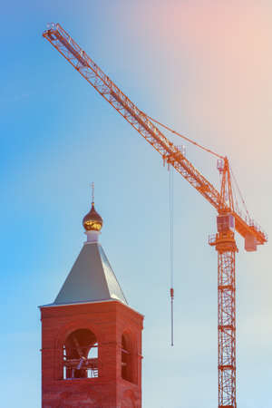 dome of the temple and a construction craneの写真素材