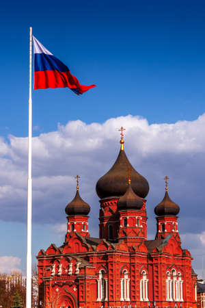 Church with black domes under the flag of Russiaの写真素材