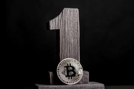 bitcoin coin and number one on a black background