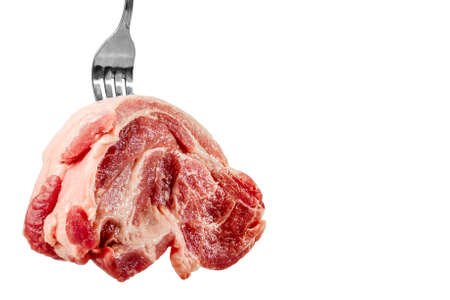 piece raw pork neck meat on metall fork. isolatedの写真素材
