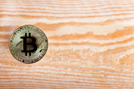 bitcoin coin on wooden background. lots of spaceの写真素材