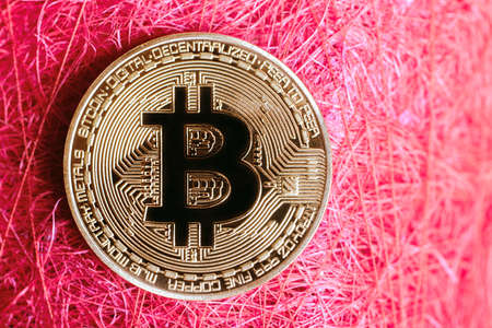 gold coin bitcoin on red backgroundの写真素材