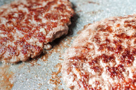 Grilled hamburger cutlets or burger patties on frying pan. closeup