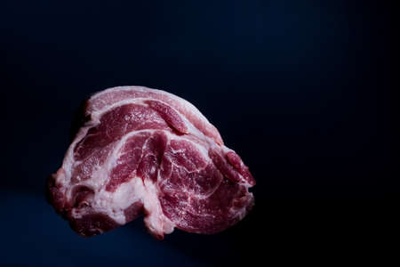 piece red raw pork neck meat on dark backgroundの写真素材