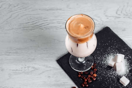 Ice korean Dalgona Coffee, a trendy fluffy creamy whipped coffee with ice. trendy coffee drink on a...