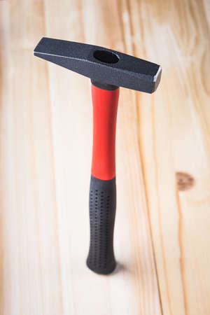 hammer is completely on a wooden background. high quality, beautiful lightの写真素材