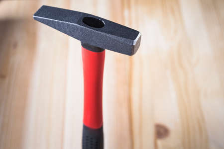quality hammer on a wooden background. close-up and high quality, beautiful light