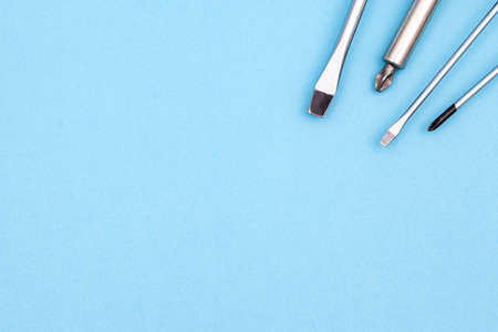 Tools worker, a lot of different screwdrivers on a blue background, top view with free spaceの写真素材