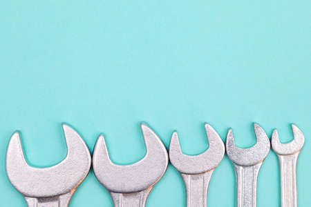 Tools worker, many wrenchs on blue background, top view with free spaceの写真素材