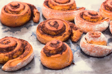 rolled bread rolls with sugar and cinnamon baked in home kitchen as an example of home cookingの写真素材