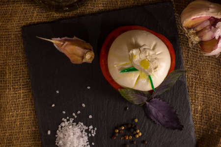 Burrata, Burata or Fresh Mozzarella Cheese with Tomato, Olive Oil, Sea Salt, Basil and garlic on...