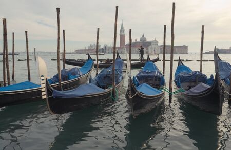 Gondolas in front of the island of San Giorgio in Venice in winter eveningのeditorial素材
