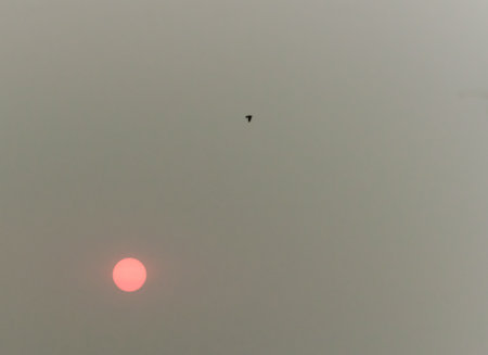 red sun over smokeの写真素材