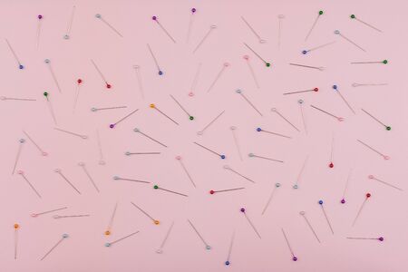 stationery needles isolated on pink backgroundの写真素材