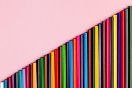 multicolored pencil ladder isolated on pink background
