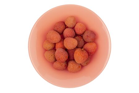 several lychee fruits lie on a coral plate on a white background, isolateの写真素材