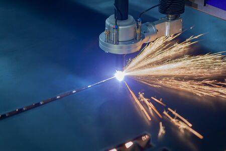 plasma cutting machine cuts metal sparks flyの写真素材