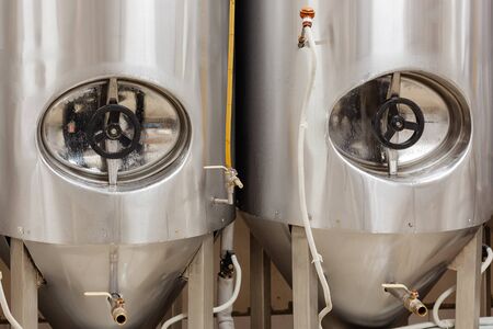 Brewery, two beer tanks, cylinder-conical fermentation tanks in drops of waterの写真素材