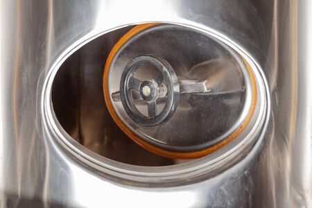 Brewery, open hatch in a beer tank, cylinder-conical fermentation tank in drops of waterの写真素材