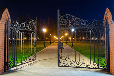the gates are ajar in the park, in the evening, the park is lit by lanternsの写真素材