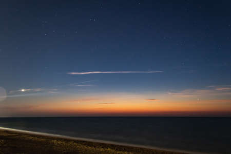 sunset over the sea, skyline, starry skyの写真素材