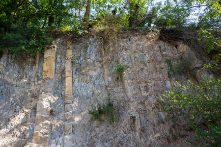 sheer rock with green trees on topの写真素材
