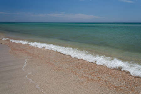 waves of beach, azure sea and white sandの写真素材