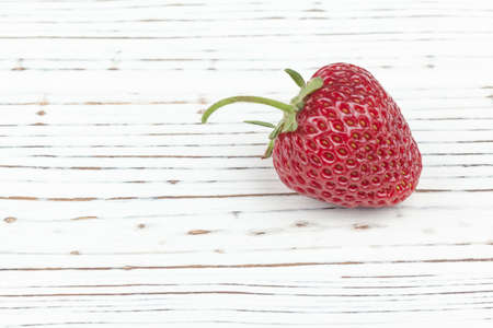 juicy ripe strawberries close-up on white painted wooden backgroundの写真素材