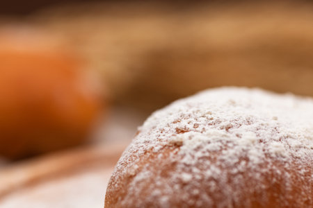 homemade bun in wheat flour close-up, use as a background or texture, place under the text, copy spaceの写真素材