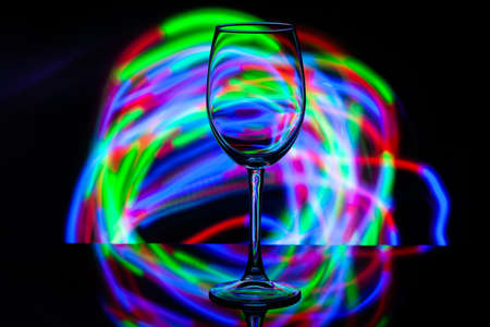 wine glass against the background of colored bright stripesの写真素材