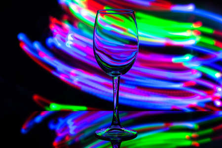 wine glass against the background of colored bright stripesの写真素材