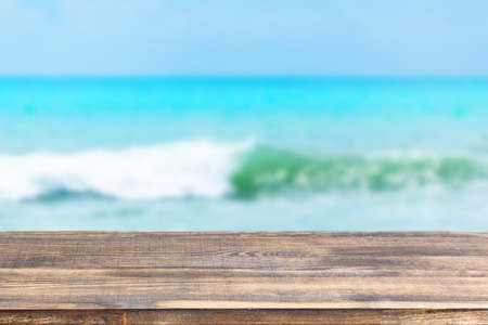 wood table top on blur sea wave background