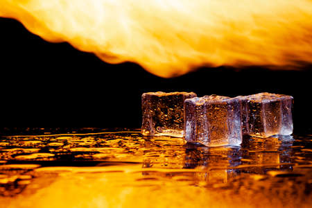 water and fire, ice and flame, black background, place under the textの写真素材