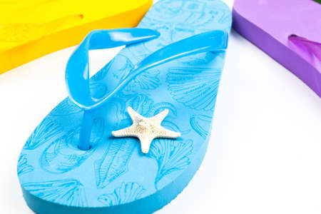 blue beach flip flop with starfish on a white backgroundの写真素材