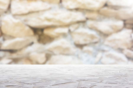 white textured surface on blur stone wall backgroundの写真素材