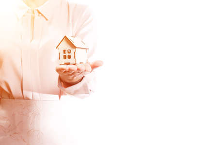 Woman holds model at home in palm, isolate