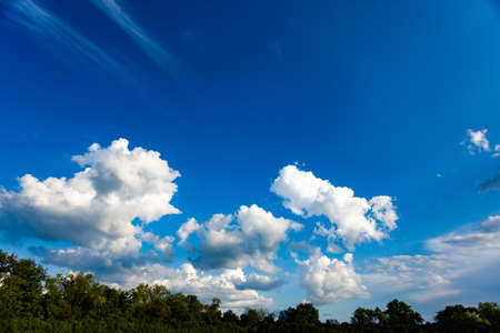 bright blue sky with white cou nomadic clouds, use as a background, place under the text
