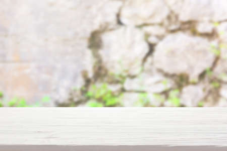 white wood table top on blur stone wall background