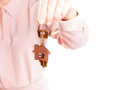 Womans hand holds the key to the apartment, isolate on a white backgroundの写真素材