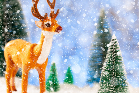 Toy deer in a snowy forest, New Year card, conceptの写真素材