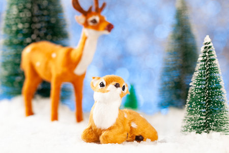 greeting new year card, two little toy deer in the snowの写真素材