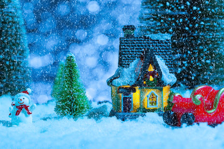 santa claus on a sleigh near the village house, it is snowing, night. New year greeting card, conceptの写真素材