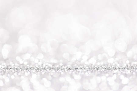 Bokeh gray background. Silver abstract bokeh snow falling winter christmas holiday backgroundの写真素材